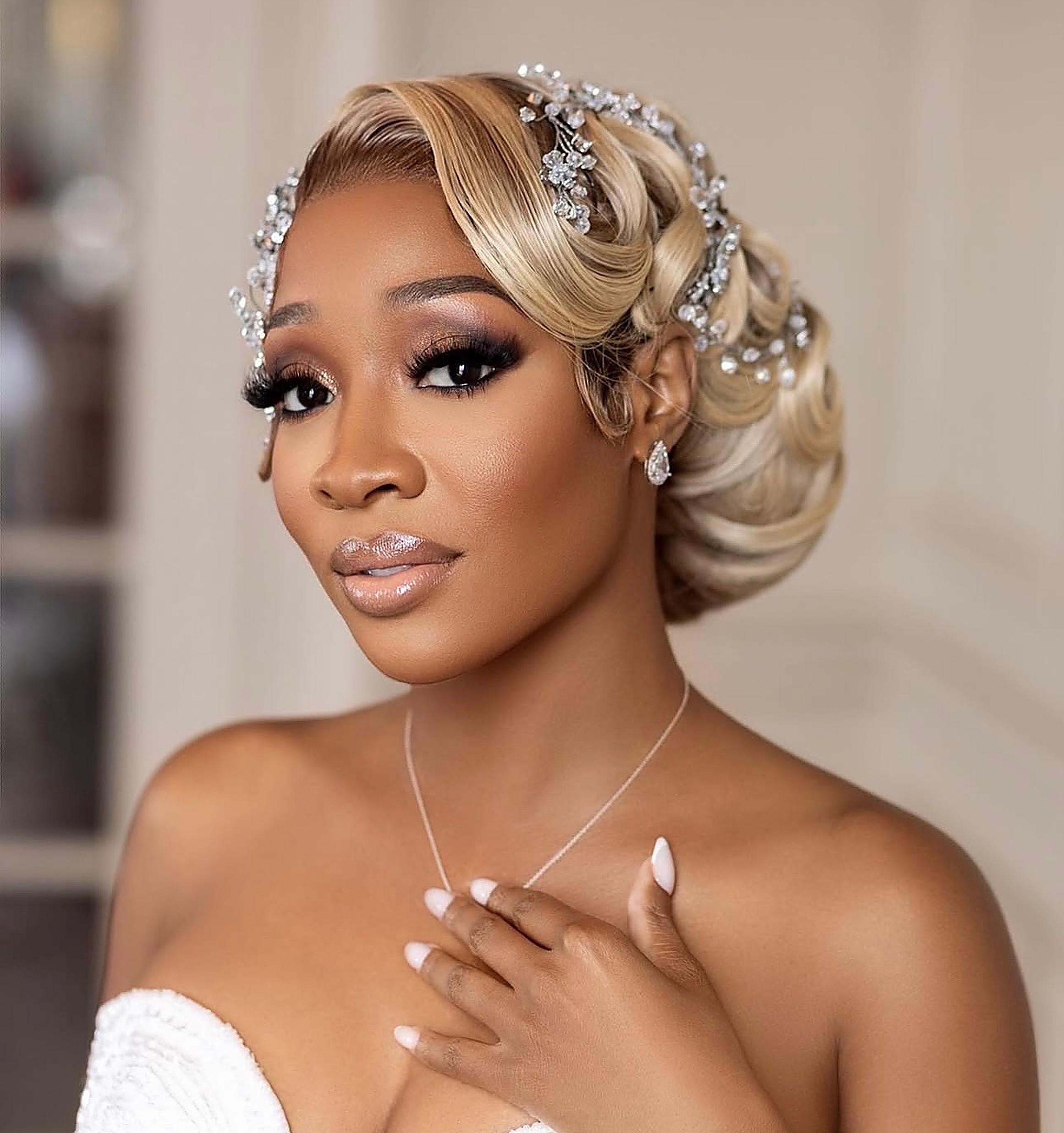 Bridal updo with crystal hairpiece and soft glam